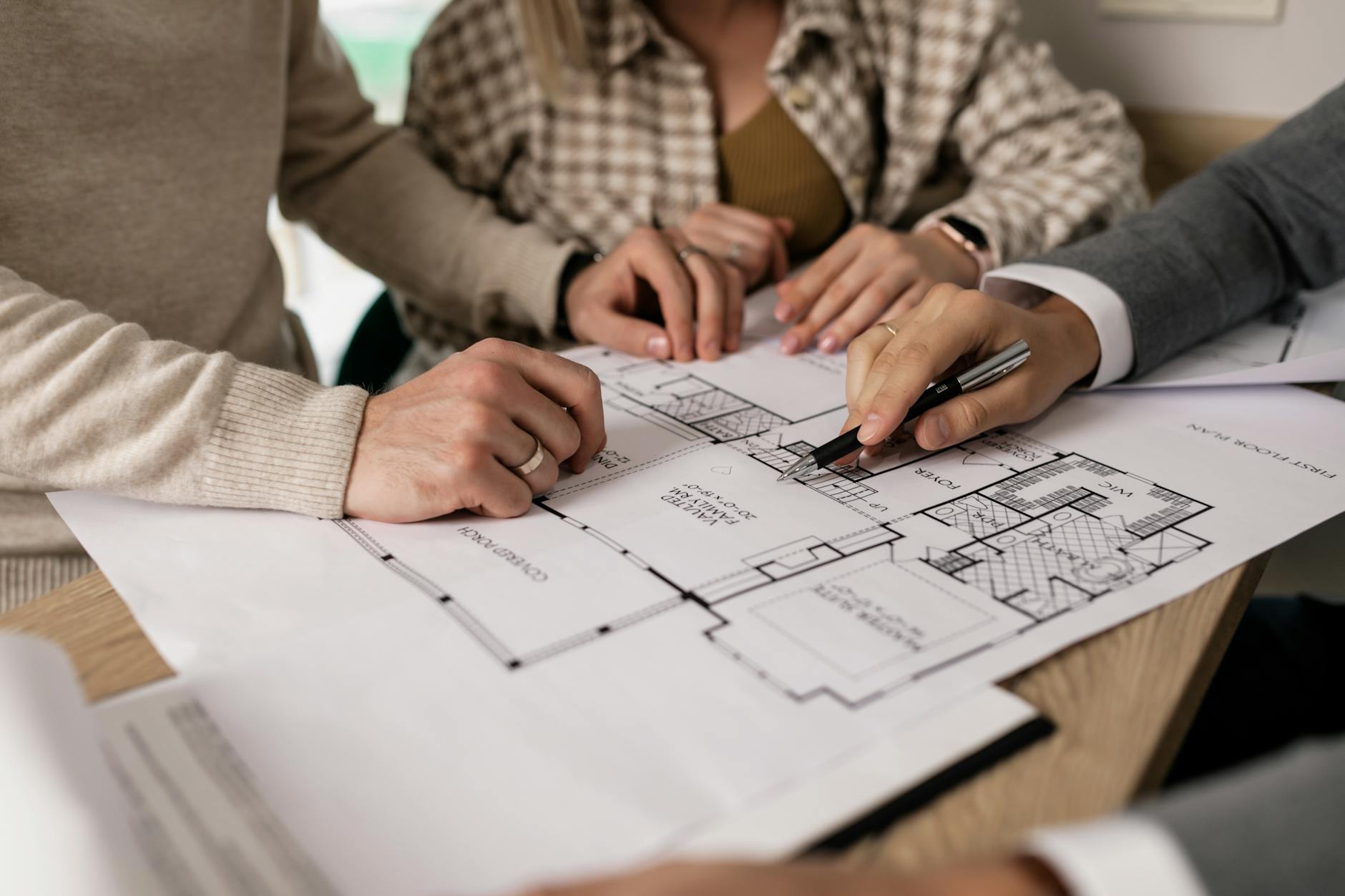 Workspace with architectural plans and investment documents